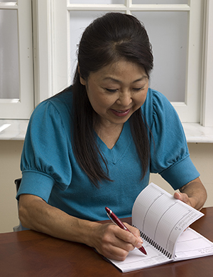 Woman writing in journal.